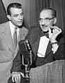 a photo of George Fenneman and Groucho Marx from 1951 with a NBC microphone of the period